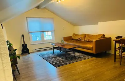 a living room with a couch and a table at Hikari-Okanagan Sunshine B&B in Kelowna