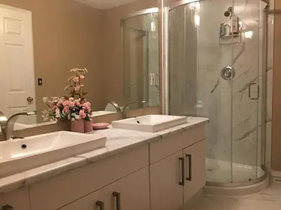 a bathroom with two sinks and a shower at Renovated 4 bedrooms 20 sleeps Shopping Center in Edmonton