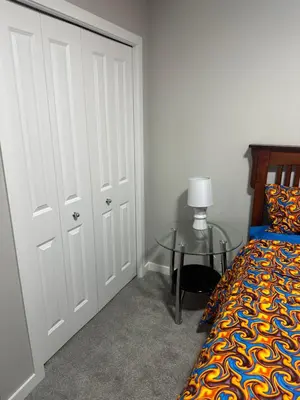 a bedroom with a bed and a glass table at 3 Bedroom House in NW Calgary in Calgary