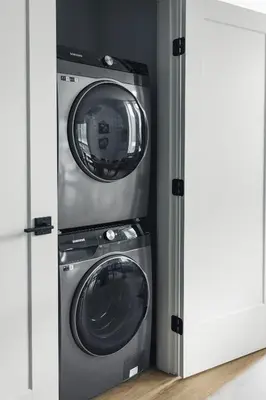 a washer and a washing machine in a kitchen at Lokis Loft and Cellar at the 1896 Building in Kaslo