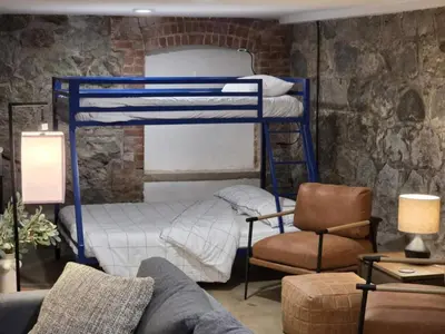 a living room with two bunk beds and a couch at Lokis Loft and Cellar at the 1896 Building in Kaslo