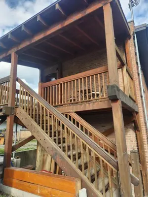a wooden deck with a staircase on a building at The Crow's Nest at the 1896 Building in Kaslo