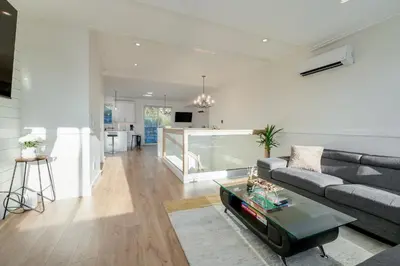 a living room with a couch and a table at Elegant Home In Victoria,BC in Langford