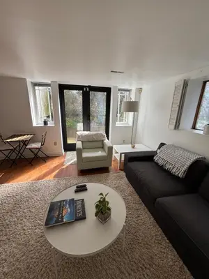 a living room with a couch and a table at Bright Garden Suite Across From Park in Kitsilano in Vancouver
