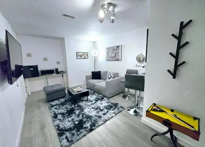 a living room with a couch and a table at Private Cozy 1Br Basement Suite Perfect for Couple! With Date Bar for 2! Self Check-in, Private Parking in Burnaby
