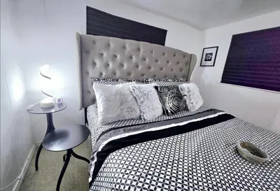 a bedroom with a large bed with a large headboard at Private Cozy 1Br Basement Suite Perfect for Couple! With Date Bar for 2! Self Check-in, Private Parking in Burnaby