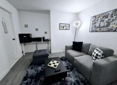 a living room with a couch and a table at Private Cozy 1Br Basement Suite Perfect for Couple! With Date Bar for 2! Self Check-in, Private Parking in Burnaby
