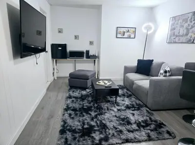 a living room with a couch and a tv at Private Cozy 1Br Basement Suite Perfect for Couple! With Date Bar for 2! Self Check-in, Private Parking in Burnaby