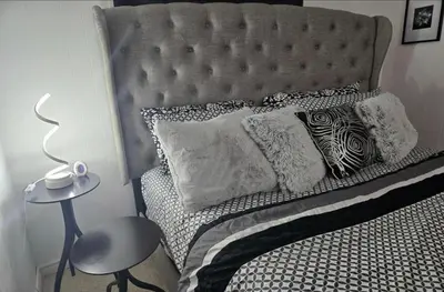 a bedroom with a bed with a gray headboard and pillows at Private Cozy 1Br Basement Suite Perfect for Couple! With Date Bar for 2! Self Check-in, Private Parking in Burnaby