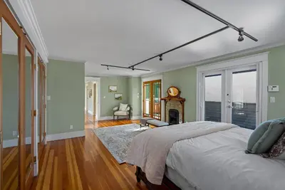 a bedroom with a bed and a fireplace at The Vancouver Heritage Home - Mount Pleasant in Vancouver