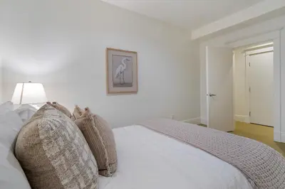 a bedroom with a white bed with pillows on it at The Vancouver Heritage Home - Mount Pleasant in Vancouver
