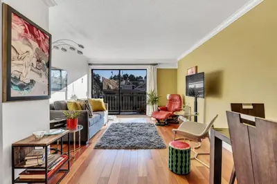 a living room with a couch and a table at Adorable 1-Bedroom Apartment on Kitsilano Beach in Vancouver