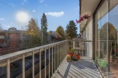 a balcony of a house with a view of the street at Adorable 1-Bedroom Apartment on Kitsilano Beach in Vancouver