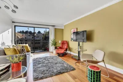 a living room with a couch and a tv at Adorable 1-Bedroom Apartment on Kitsilano Beach in Vancouver
