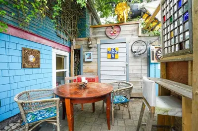 a patio with a table and chairs and a shed at Artsy Private Guest Suite with Outdoor Saloon in Vancouver