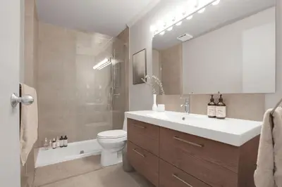 a bathroom with a sink and a toilet and a shower at Modern and Specious Condo right off Main St in Vancouver