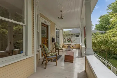 a porch with chairs and a table at The Queen Elizabeth Park Home in Vancouver