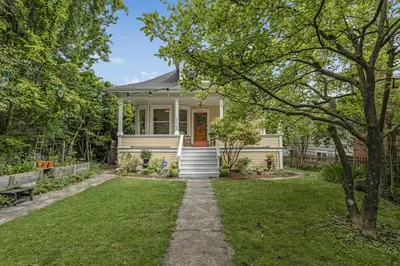 a small white house with a lawn at The Queen Elizabeth Park Home in Vancouver