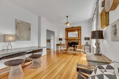 a living room with white walls and a wooden floor at The Queen Elizabeth Park Home in Vancouver