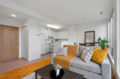 a living room with a couch and a table at Central Downtown Highrise Condo in Vancouver