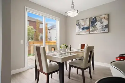 a dining room with a table and chairs and a window at A beautiful home in Airdrie in Airdrie