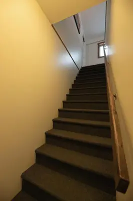 a staircase in an office building with a stair case at Located in Downtown Whitehorse - Treehouse in Whitehorse