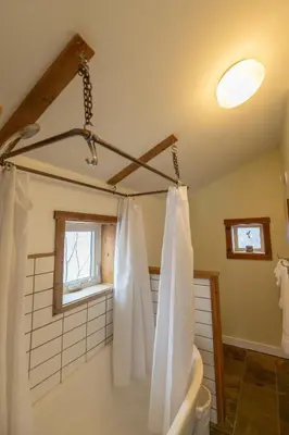 a bathroom with a tub and a shower curtain at Located in Downtown Whitehorse - Treehouse in Whitehorse