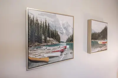 two paintings on a wall with boats on a lake at New 1Bd Luxe King Suite with Superb Mtn View in Canmore