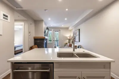 a kitchen with a sink and a counter at New 1Bd Luxe King Suite with Superb Mtn View in Canmore