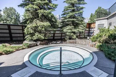 a swimming pool in the middle of a yard at Stunning Silver Creek 1Br Mtn view penthouse in Canmore