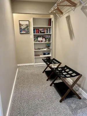 a room with two tables and a book shelf at Five Gables B&B in Qualicum Beach