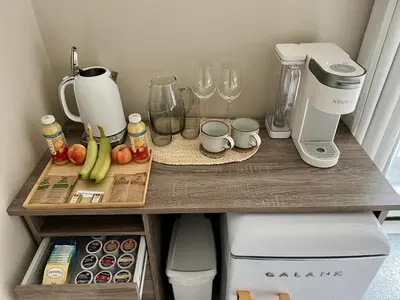 a kitchen counter with a coffee maker and a blender at Five Gables B&B in Qualicum Beach