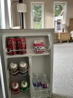 an open refrigerator filled with drinks and soda at Five Gables B&B in Qualicum Beach