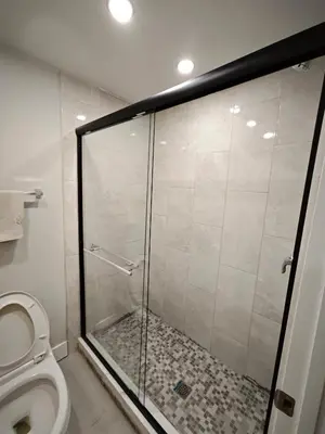 a shower stall in a bathroom with a toilet at Chamber Inn in Edmonton