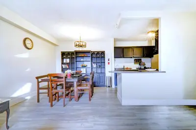 a kitchen and dining room with a table and chairs at Spacious Top Floor at Stampede w Free Parking and AC in Calgary