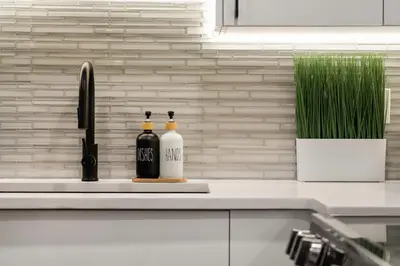 two bottles of wine sitting on a kitchen counter at Luxury Living Entire Suite-Private in Calgary