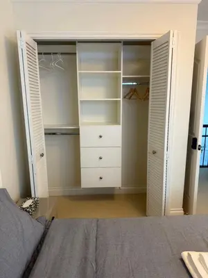 a bedroom with a closet with white closets at The Ester House in Vancouver