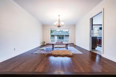an empty living room with a table and a window at The Ester House in Vancouver