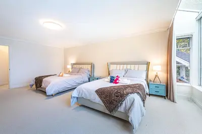 a bedroom with two beds with teddy bears on them at The Ester House in Vancouver