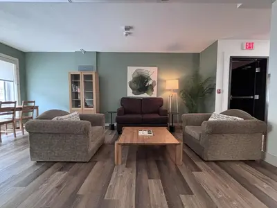 a living room with two couches and a coffee table at Jasper East Hostel - Near Jasper National Park East Gate Entrance in Jasper