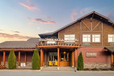 a home with a building with the words supportive living at Sproat Lake Landing Resort in Port Alberni