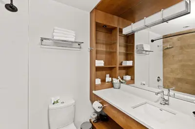 a bathroom with a sink and a toilet and a mirror at Sproat Lake Landing Resort in Port Alberni
