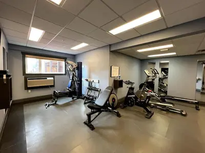 a gym with several treadmills and exercise bikes at Cornerstone Lodge by StayIn in Fernie