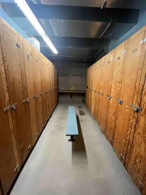 a row of lockers with a blue bench in a room at Cornerstone Lodge by StayIn in Fernie