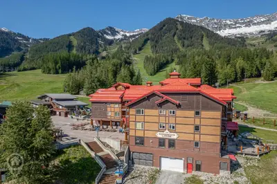 an aerial view of a building with a mountain at Cornerstone Lodge by StayIn in Fernie