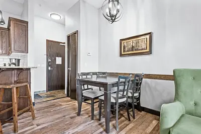 a dining room with a table and chairs at Mountain Getaway in Canmore - Sleeps 6 - Pool & Hottub in Canmore