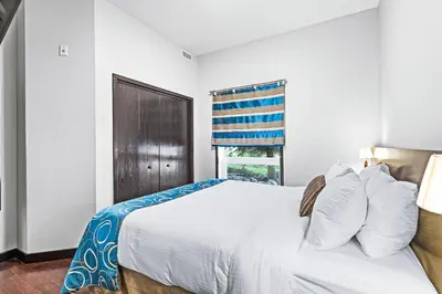 a bedroom with a white bed and a window at Mountain Getaway in Canmore - Sleeps 6 - Pool & Hottub in Canmore
