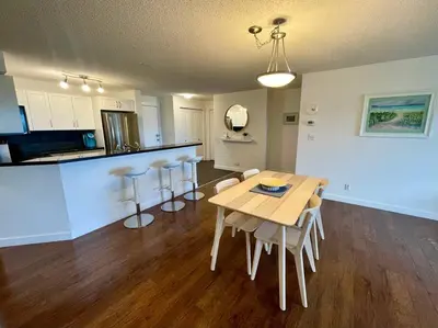 a kitchen and dining room with a table and chairs at Lake View From Every Window! in Invermere