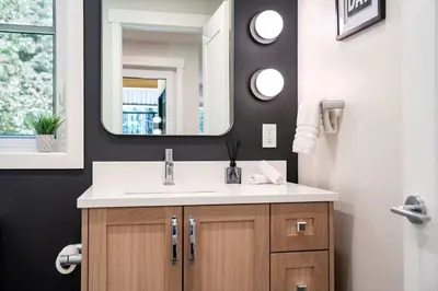 a bathroom with a sink and a mirror at The Cedar Suite - Secluded Mountain Retreat with Forest Views and Hot Tub in Revelstoke