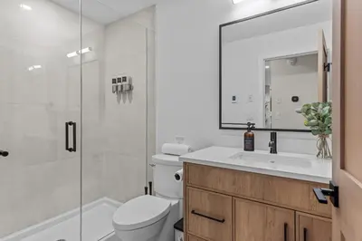 a bathroom with a toilet and a sink and a shower at Sisters Summit Villa by WeekAway Vacations in Canmore